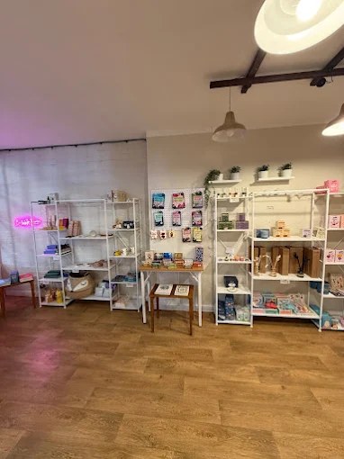 Shelves of gifts, stationery and keepsakes beside the pink neon Bubble Tea sign